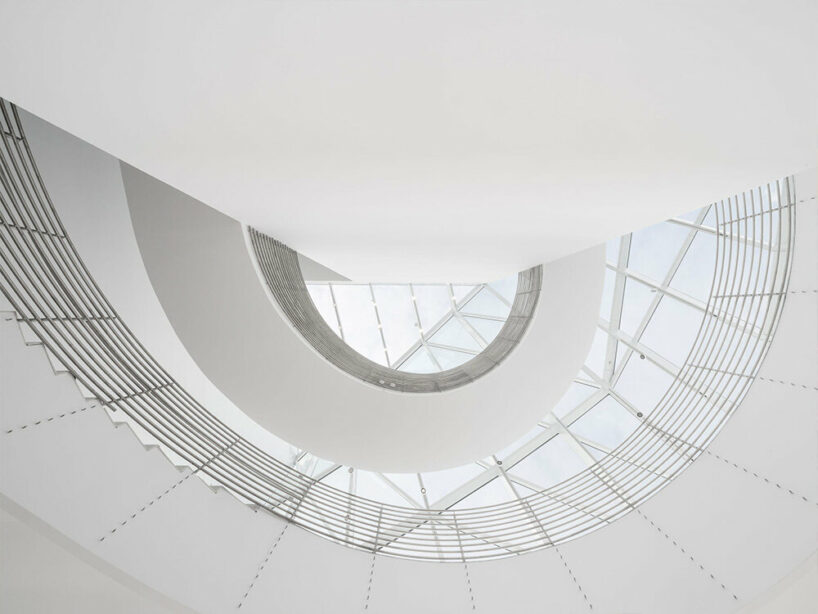 the museum welcomes the public under its transparent facade