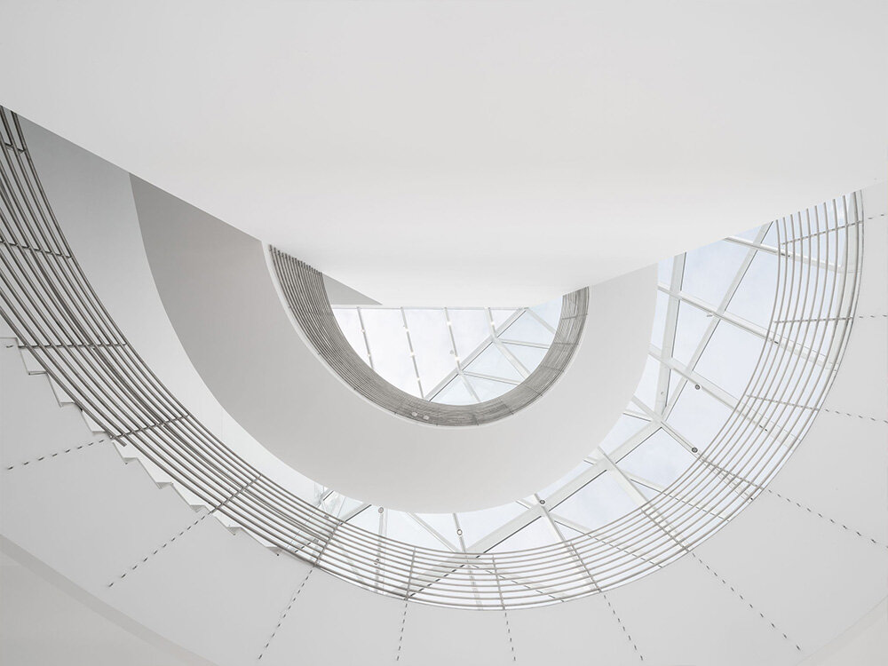 the museum welcomes the public under its transparent facade