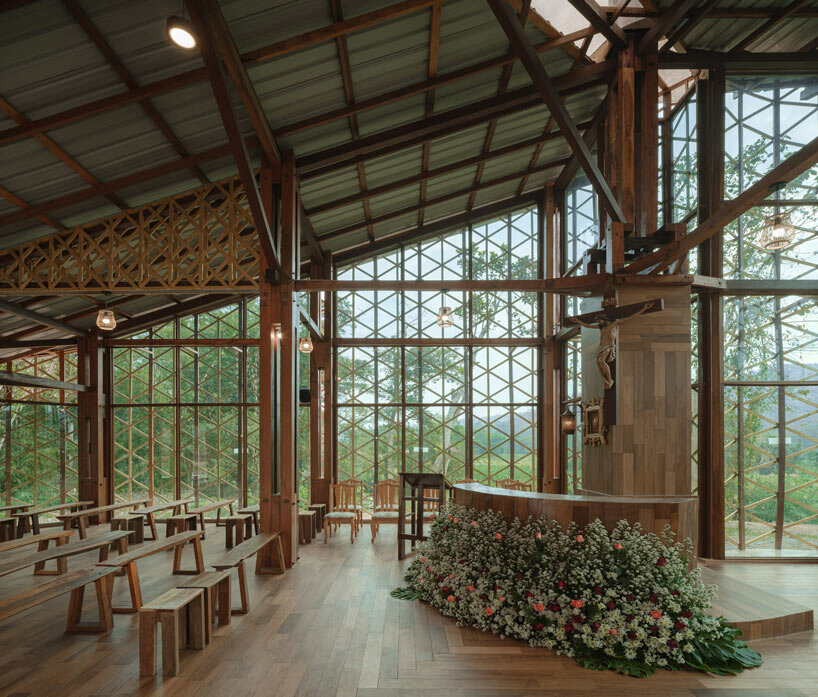 intricate timber latticework envelops st francis oratory amidst thailand’s serene landscapes