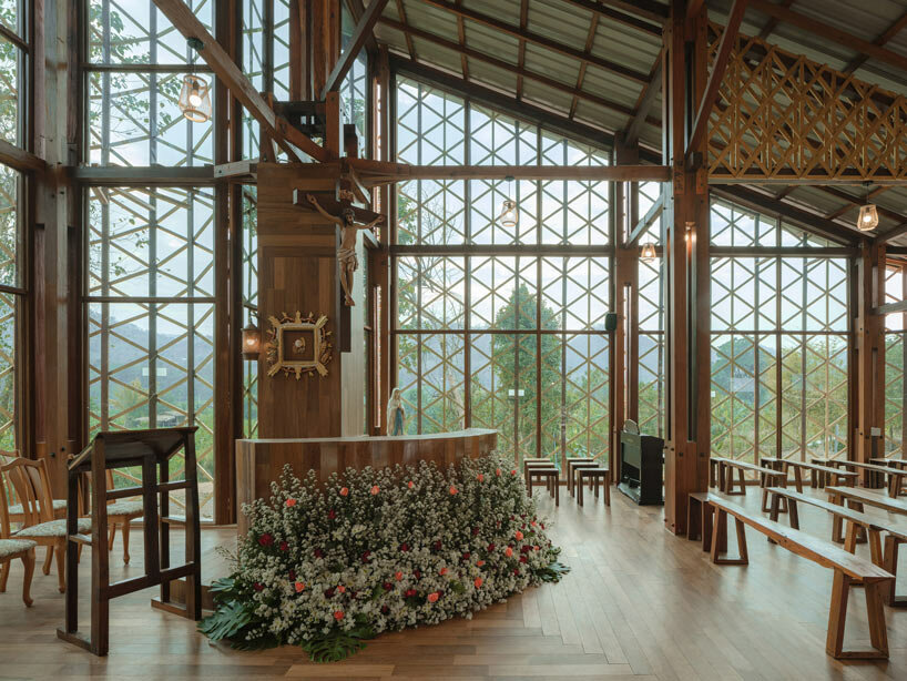 intricate timber latticework envelops st francis oratory amidst thailand’s serene landscapes