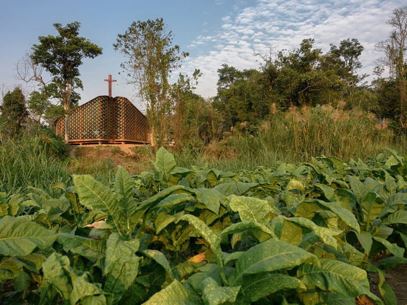 intricate timber latticework envelops st francis oratory amidst thailand’s serene landscapes