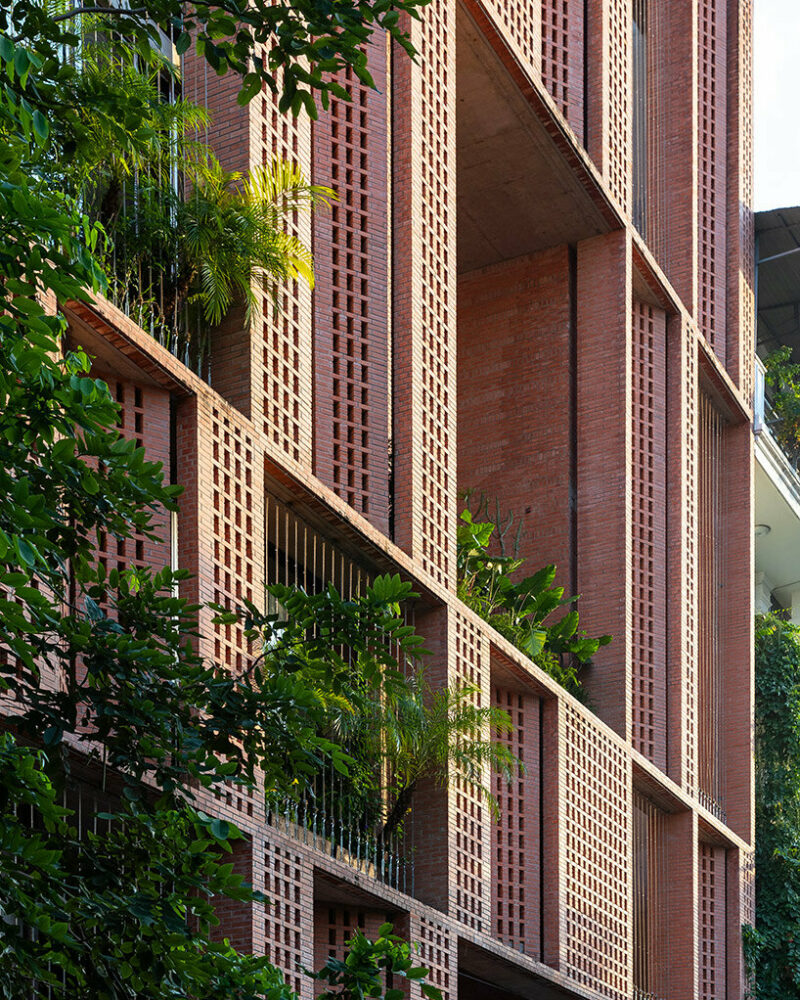 tropical space encloses this ‘premier office’ with a facade of porous brick shutters