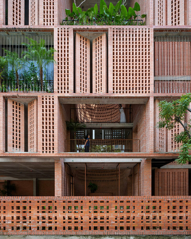 tropical space encloses this ‘premier office’ with a facade of porous brick shutters