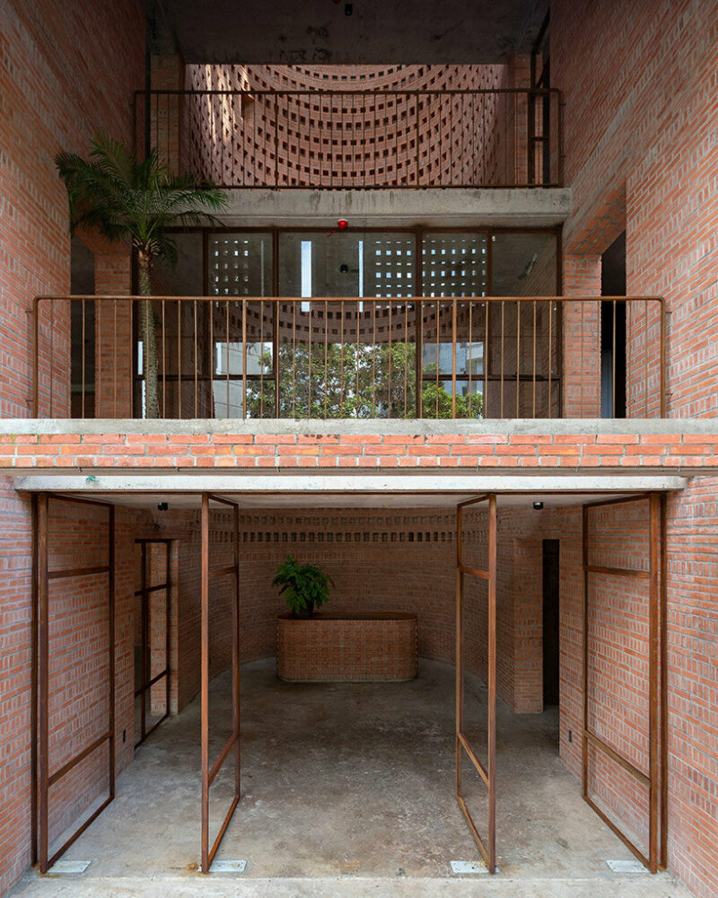 tropical space encloses this ‘premier office’ with a facade of porous brick shutters