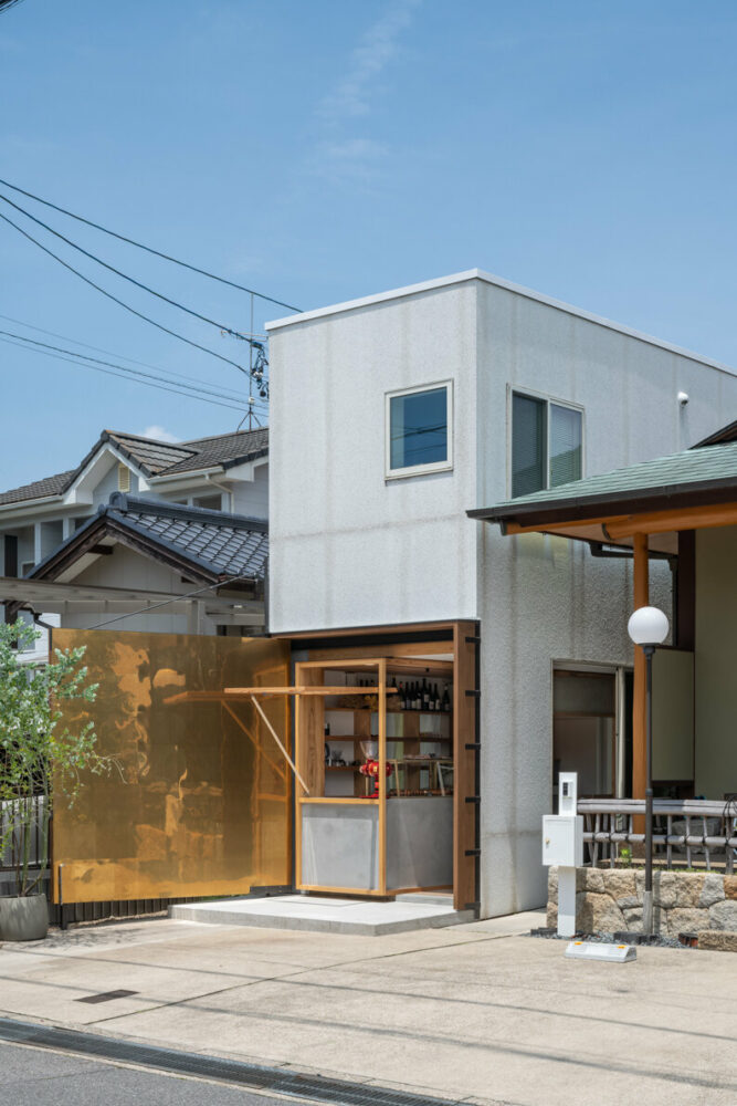 maki yoshimura wedges tiny box-like bakery shop between two houses in japan