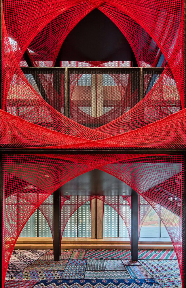 150,000 meters of vibrant red brocade threads compose immersive installation in china