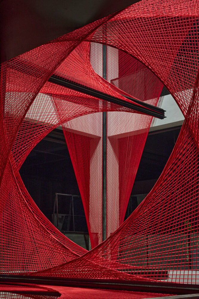 150,000 meters of vibrant red brocade threads compose immersive installation in china