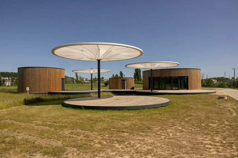 bebunch’s wooden pavilions, ponds, and umbrella canopies weave through public park