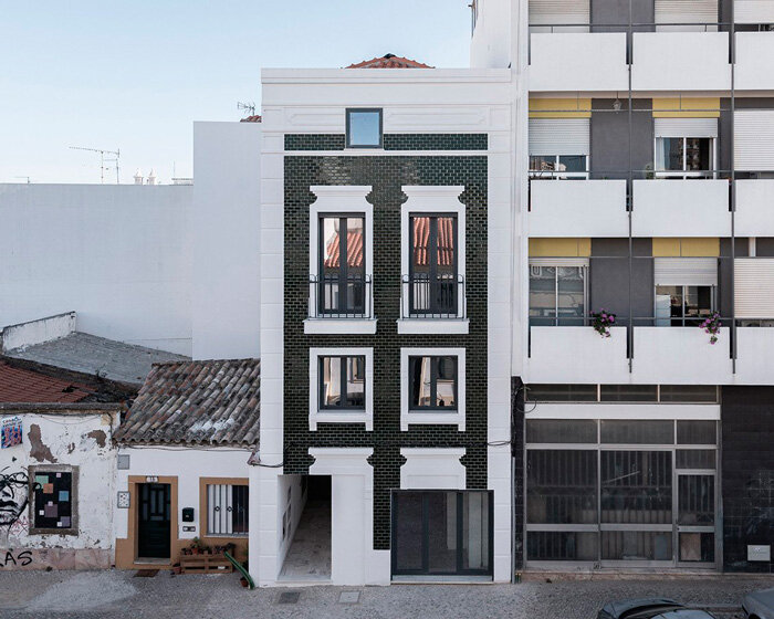 corpo atelier adheres tiled facade and window frame fragments to building in portugal