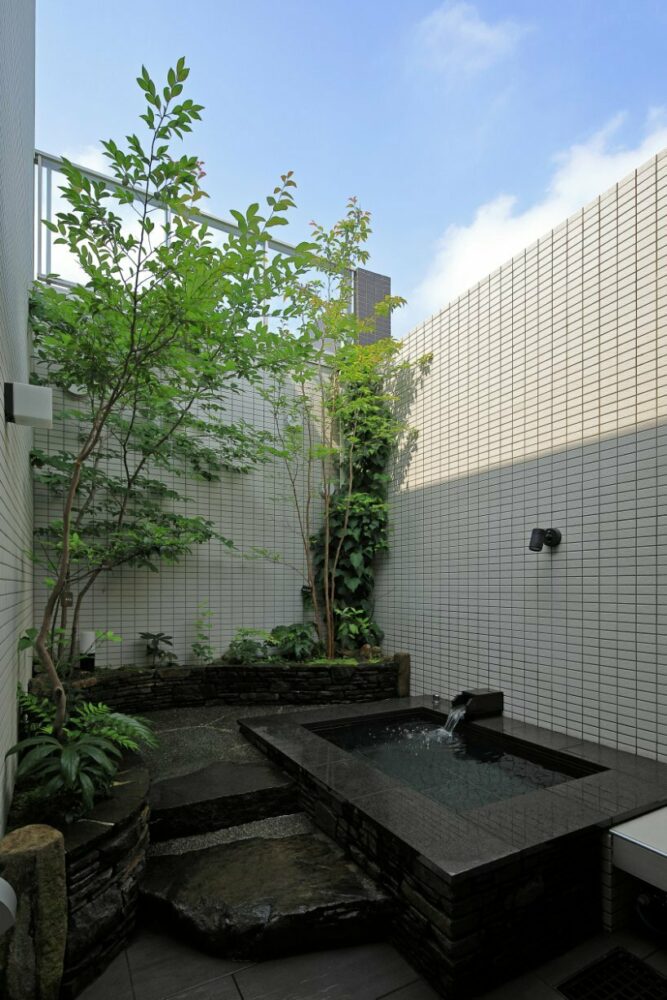 open courtyards embed natural greenery within the living spaces of residence in japan