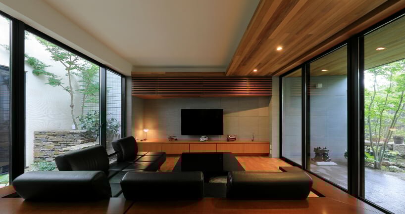 open courtyards embed natural greenery within the living spaces of residence in japan
