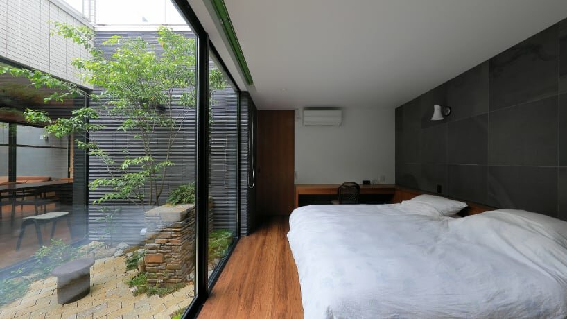 open courtyards embed natural greenery within the living spaces of residence in japan