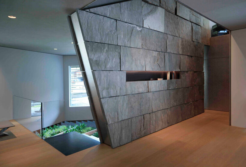 stone and wood dominate the interior, creating a visual connection to the outside