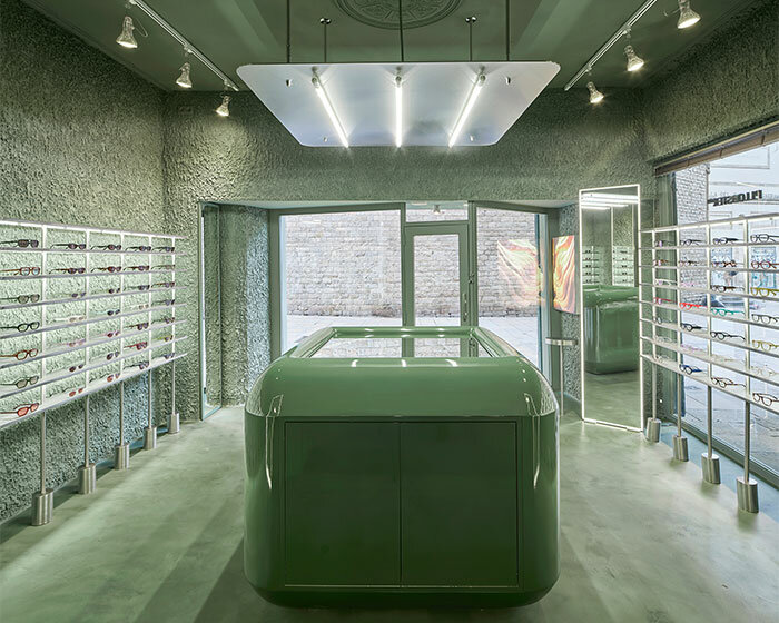 high-tech elements and 'texturized minimalism' shape all-green optical boutique in barcelona