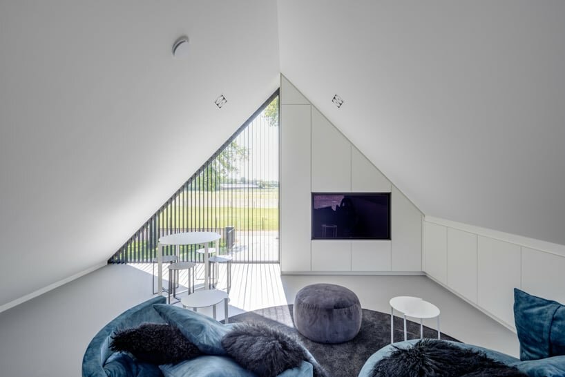 from the inside, carefully crafted openings offer views of the tree canopies