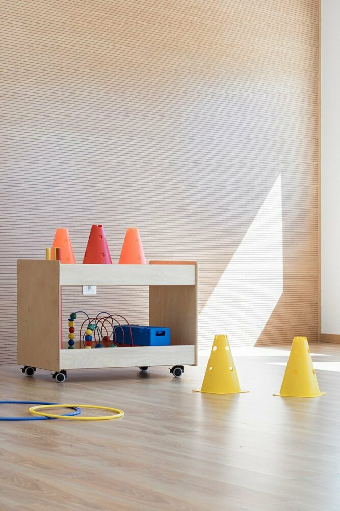 vibrant multipurpose room breathes new life into kindergarten in italy