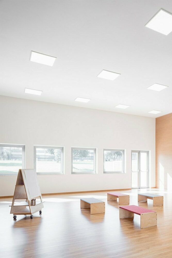 vibrant multipurpose room breathes new life into kindergarten in italy