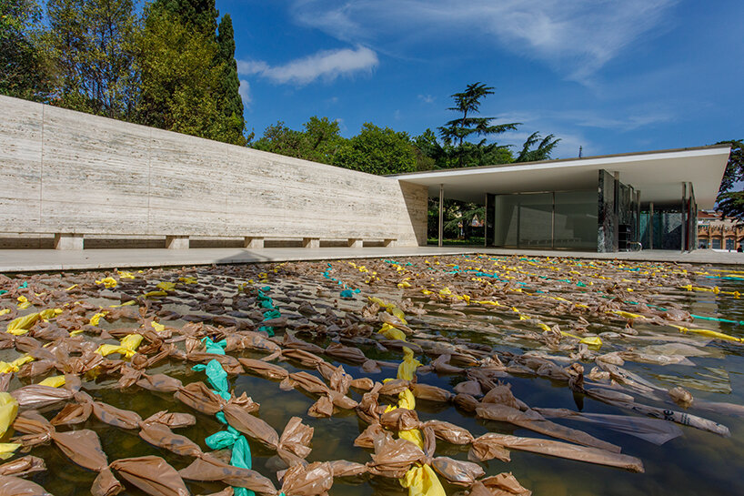 endless plastic bags fill mies van der rohe’s barcelona pavilion to spotlight the cost of money