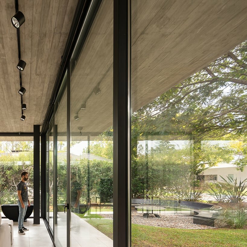 thin reinforced concrete sheet hovers above the glazed living room of house jp in argentina