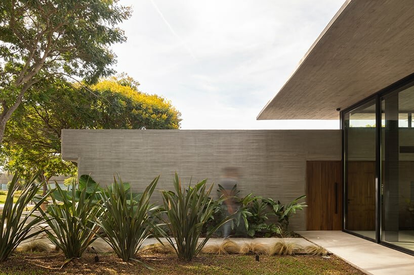 thin reinforced concrete sheet hovers above the glazed living room of house jp in argentina