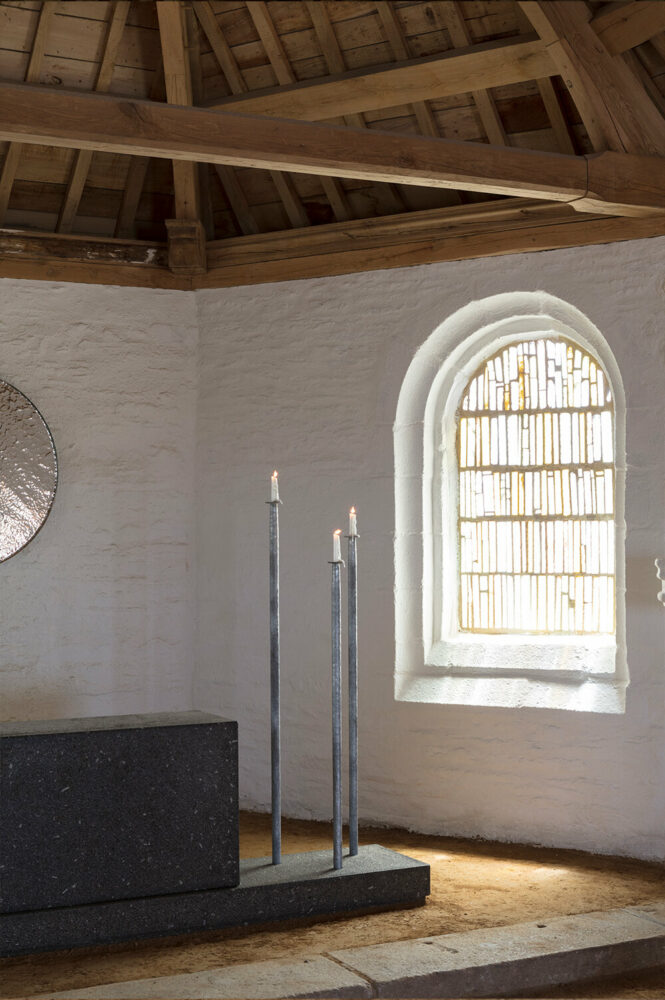 the galvanized finish softens the contrast between the cross, candlesticks, and the whiteness of the walls
