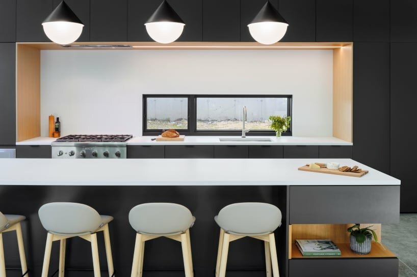 monochrome wood-clad house by studio mm nestles along sloped site in upstate new york