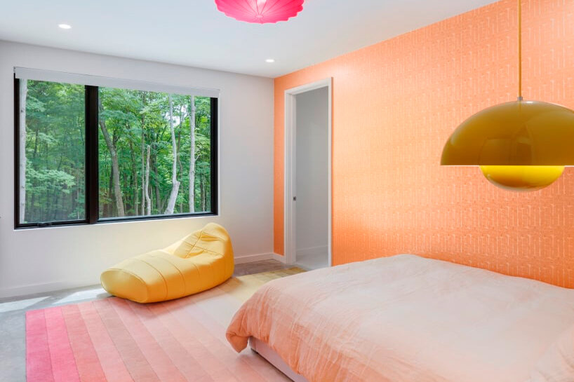 monochrome wood-clad house by studio mm nestles along sloped site in upstate new york