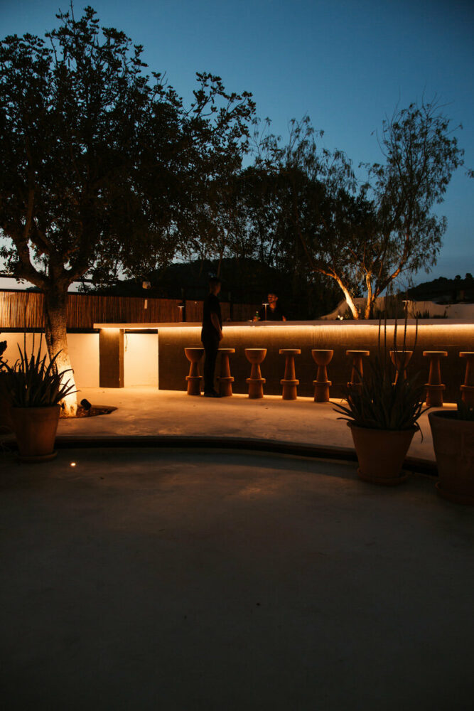 rattan chairs, mosaic tabletops, cotton, and linen fabrics complete the space