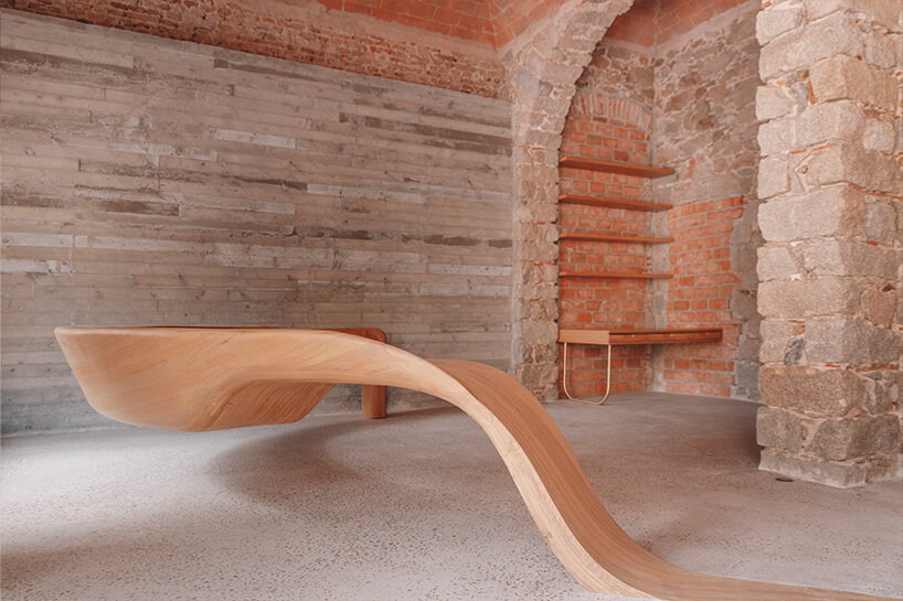 amelia tavella's curvilinear furniture-sculpture hybrid twists from seat to desk 