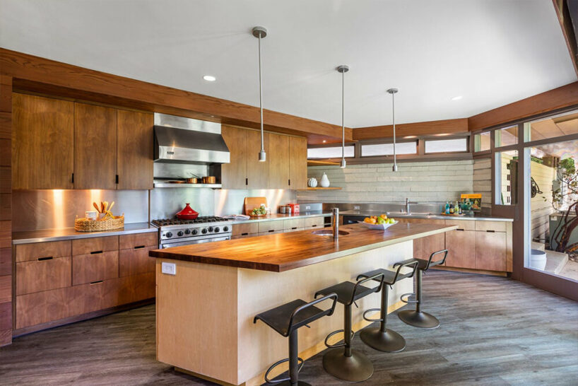 the kitchen features black walnut cabinetry, stainless steel countertops, a center island, and a 6-burner Viking Range