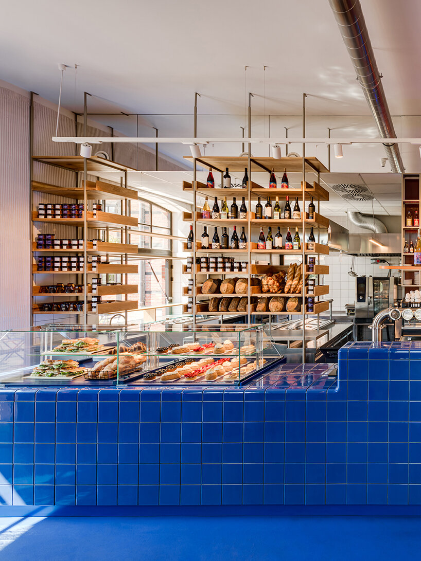 cobalt blue and warm orange tones pair up inside poland's pastry club woda - 7