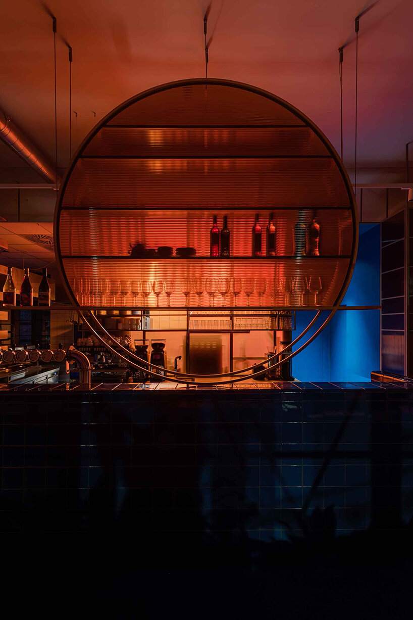 cobalt blue and warm orange tones pair up inside poland's pastry club woda - 8