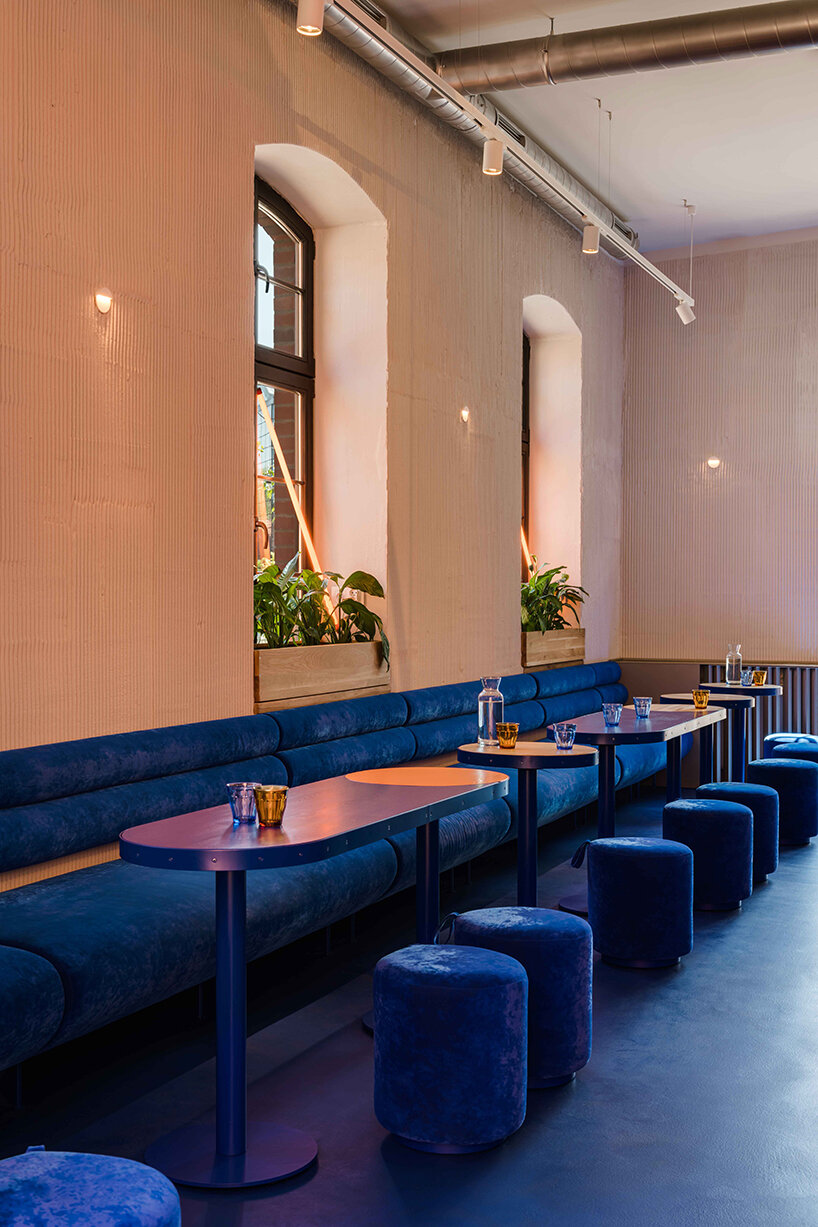 cobalt blue and warm orange tones pair up inside poland's pastry club woda - 6