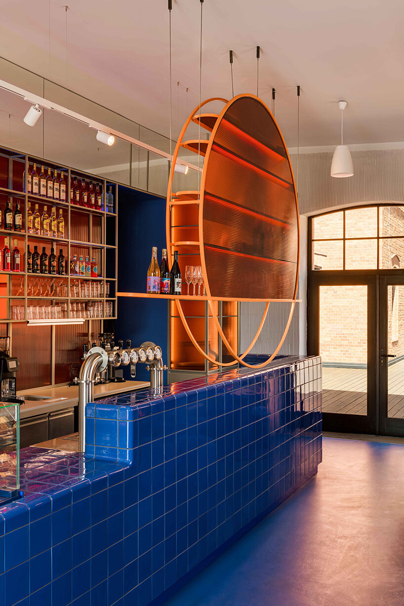 cobalt blue and warm orange tones pair up inside poland's pastry club woda - 5
