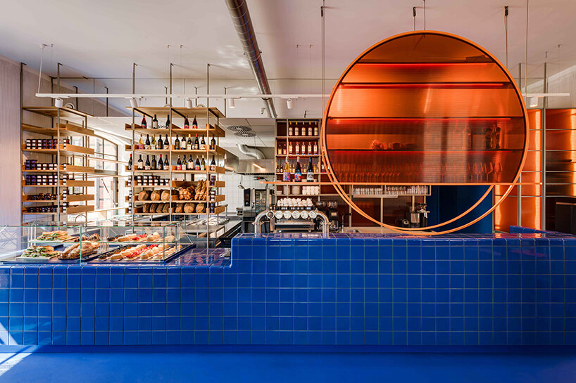 cobalt blue and warm orange tones pair up inside poland's pastry club woda - 4