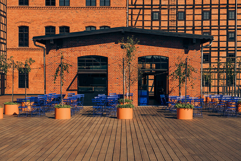 cobalt blue and warm orange tones pair up inside poland's pastry club woda - 2