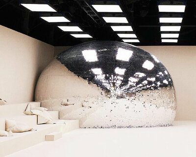 giant disco ball with reflective shards crashed acne studios SS24 women's show in paris