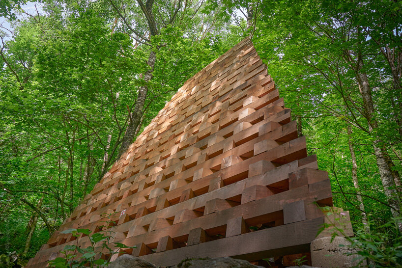 davide macullo's interwoven timber pavilions nestle in the swiss alps woodland 