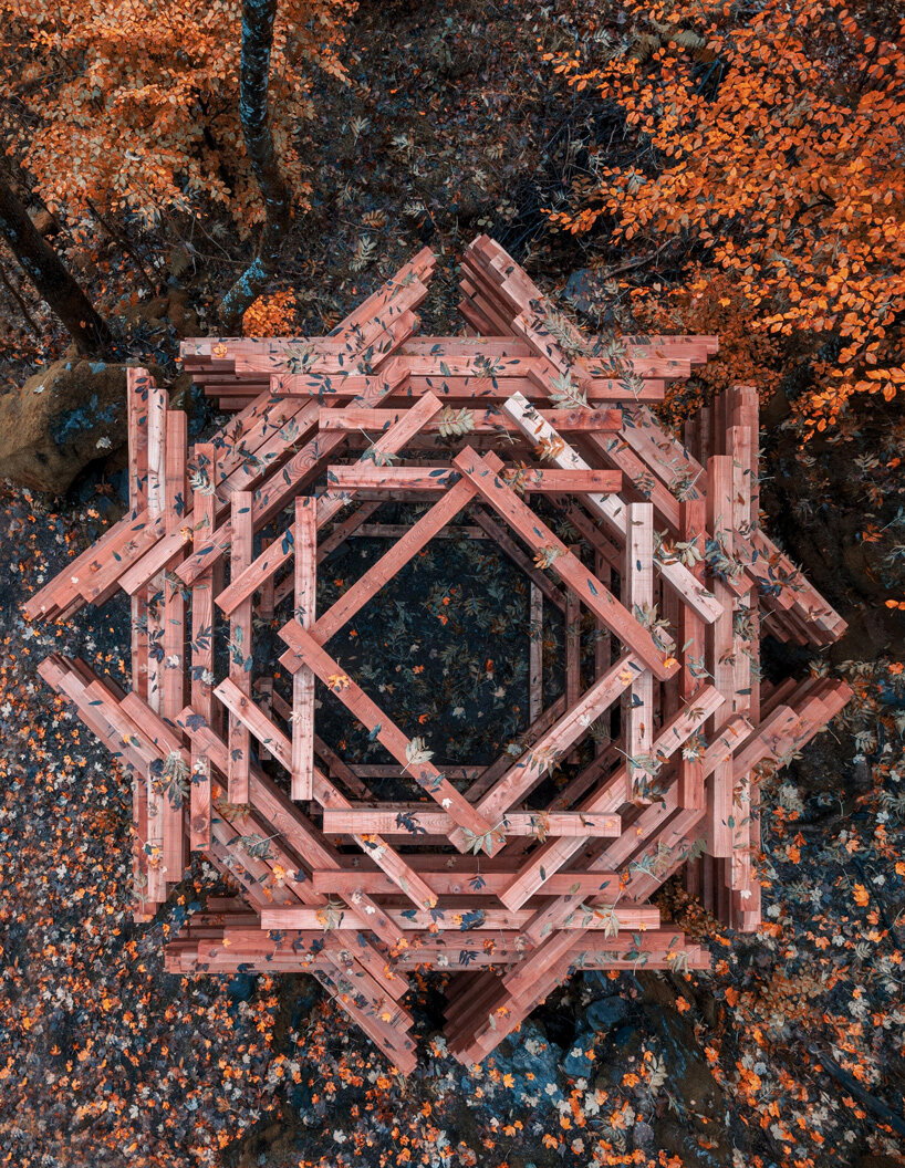 davide macullo's interwoven timber pavilions nestle in the swiss alps woodland 