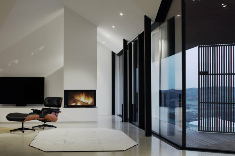 the interior is generously glazed to open up offering views of the natural surroundings