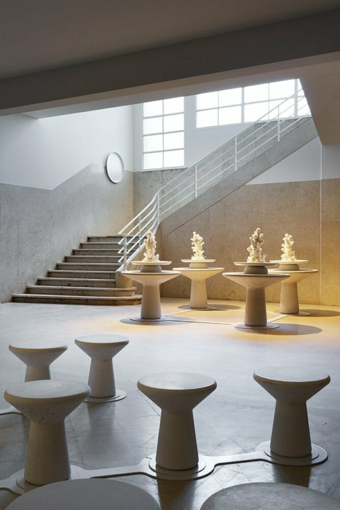 white metal plates are affixed against the walls of the imposing stairway