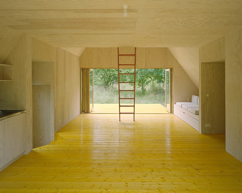 pine plywood panels are employed for both the exterior facade and interior walls