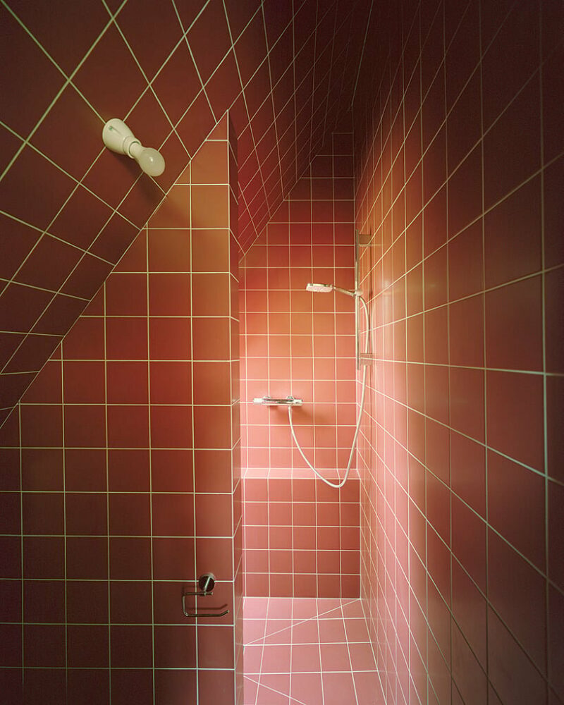 the bathroom receives natural light through a small window, creating an introverted space