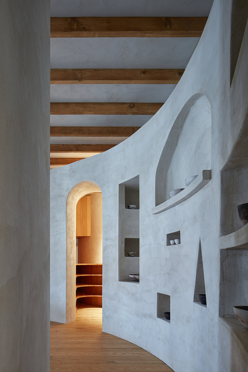 open-plan apartment in prague integrates hidden niches, arches & intricate patterns