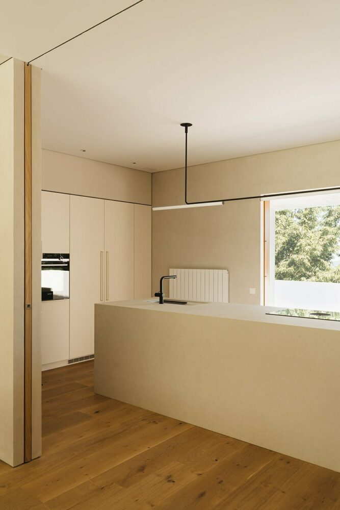 the interior decoration features noble woods, soft creams, and stone-like textures