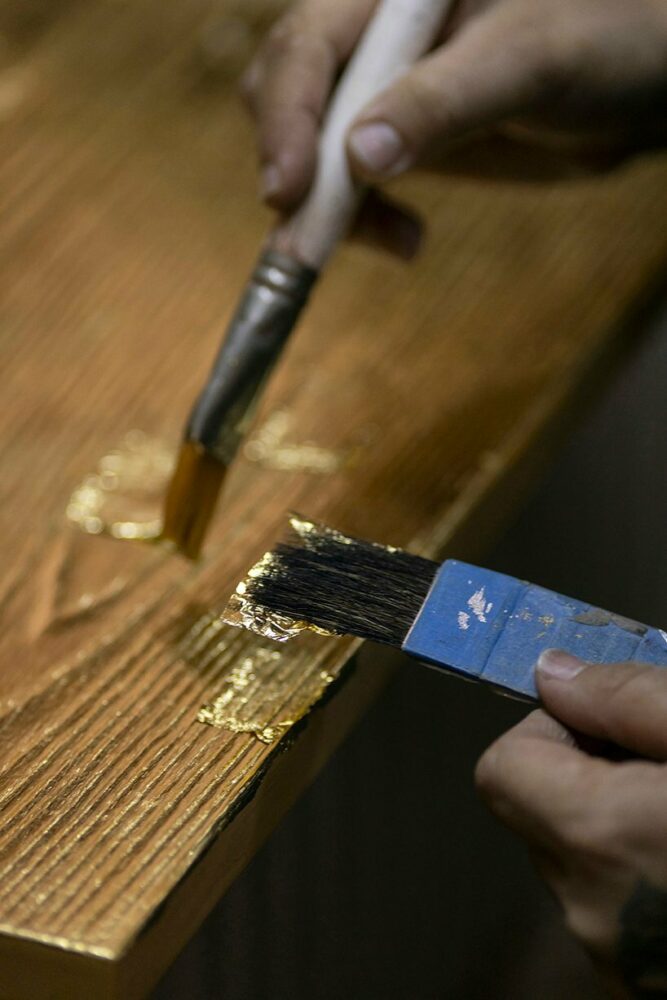 wooden AURUM cabinets clad in 23-karat gold leaf offer various configurations