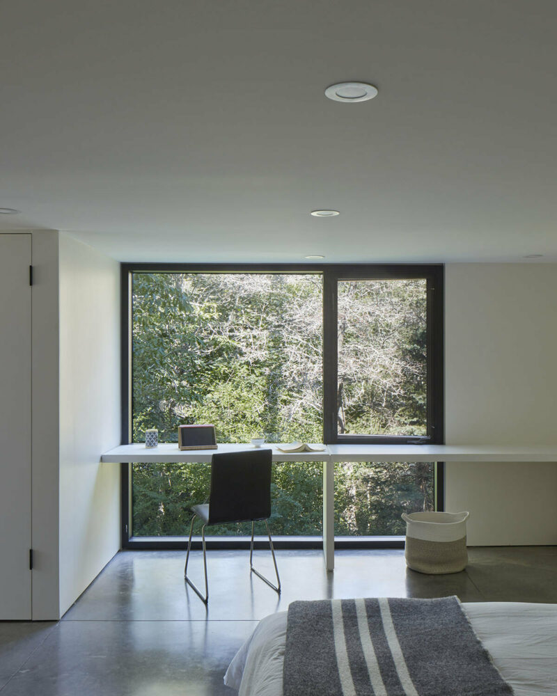 with its large picture windows, the upper level opens out toward views of the forest