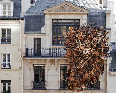 tadashi kawamata nests a tower of wooden chairs onto liaigre's parisian mansion facade