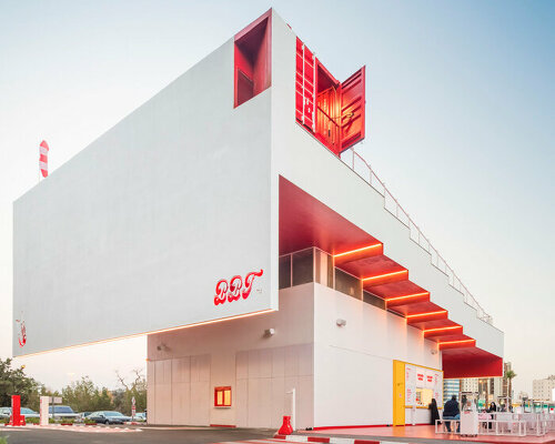 stepped multifunctional canopy colored in bright red and white emerges in kuwait