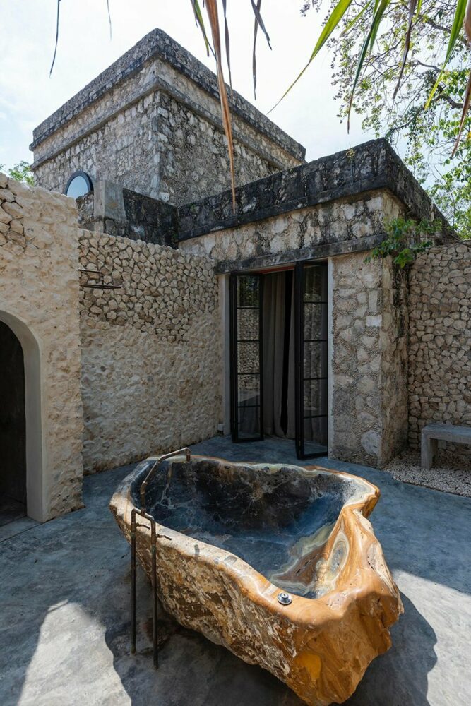 the master bedroom boasts a monolithic onyx tub and sauna